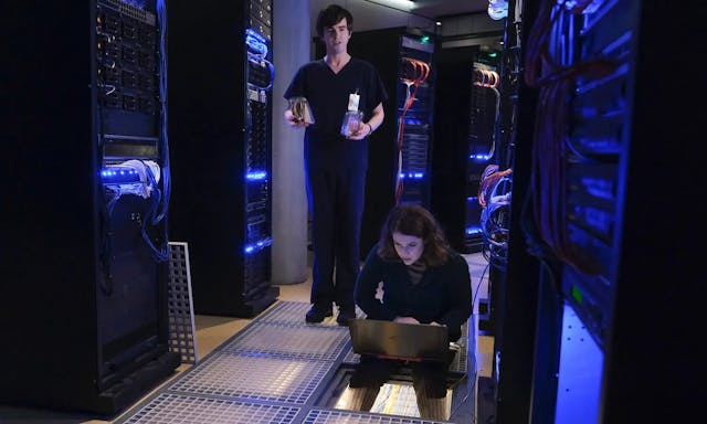 a man and woman in a server room