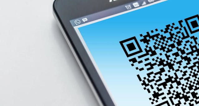 a close-up of a smartphone with qr code
